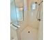 A bright white tiled shower stall with glass divider and window at 20472 W Daniel Pl, Buckeye, AZ 85396