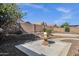 A view of the desert-landscaped backyard with a water fountain and a brick perimeter wall at 21616 E Calle De Flores --, Queen Creek, AZ 85142