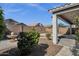 A view of the backyard showing the patio and desert landscaping with a water fountain at 21616 E Calle De Flores --, Queen Creek, AZ 85142