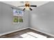 Comfortable bedroom with a ceiling fan and sunlit window overlooking lush greenery at 21616 E Calle De Flores --, Queen Creek, AZ 85142