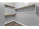 A simple yet functional walk-in closet with multiple shelves for organizing and storage at 21616 E Calle De Flores --, Queen Creek, AZ 85142