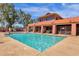 Community swimming pool featuring clear blue water and relaxing seating areas in a gated enclosure at 21616 E Calle De Flores --, Queen Creek, AZ 85142