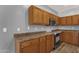 Well-lit kitchen with wood cabinets, brown countertops, and modern stainless-steel appliances at 21616 E Calle De Flores --, Queen Creek, AZ 85142