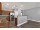 Well-lit kitchen with stainless steel appliances, wood cabinets, and breakfast bar at 21616 E Calle De Flores --, Queen Creek, AZ 85142
