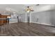 Open-concept floorplan featuring dark wood floors, gray walls, and a view to the kitchen at 21616 E Calle De Flores --, Queen Creek, AZ 85142