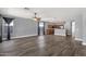 Open floorplan showcasing dark wood floors, gray walls, and a view to the kitchen at 21616 E Calle De Flores --, Queen Creek, AZ 85142