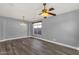 Spacious living room with hardwood floors, ceiling fan, and large window for a bright and airy feel at 21616 E Calle De Flores --, Queen Creek, AZ 85142