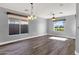 Bright living room features hardwood floors, recessed lighting, and large windows for natural light at 21616 E Calle De Flores --, Queen Creek, AZ 85142