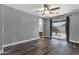 Serene main bedroom with wood-look floors, ceiling fan, and access to the backyard through sliding glass doors at 21616 E Calle De Flores --, Queen Creek, AZ 85142