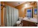 Bathroom features a shower-tub combo, a toilet, and vanity with good lighting at 23104 W Kimberly Dr, Buckeye, AZ 85326