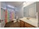 Bright bathroom with a colorful unicorn shower curtain and a single sink vanity at 23104 W Kimberly Dr, Buckeye, AZ 85326