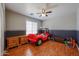 Playful room featuring a racecar bed, wood flooring, and a ceiling fan at 23104 W Kimberly Dr, Buckeye, AZ 85326