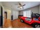 Fun bedroom featuring a racecar bed, hardwood floors, and a ceiling fan at 23104 W Kimberly Dr, Buckeye, AZ 85326