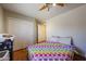 Cozy bedroom featuring colorful polka dot bedding, closet, and neutral wall paint at 23104 W Kimberly Dr, Buckeye, AZ 85326