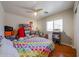 Bright bedroom featuring a colorful bedspread and a large window at 23104 W Kimberly Dr, Buckeye, AZ 85326