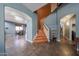 Spacious entryway with tile flooring, staircase, and views to the dining area at 23104 W Kimberly Dr, Buckeye, AZ 85326