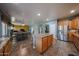 Spacious kitchen with tile floors, stainless steel appliances, an island, and honey colored cabinetry at 23104 W Kimberly Dr, Buckeye, AZ 85326