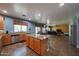 Bright, open kitchen featuring an island, tile floors, stainless steel appliances, and tan granite countertops at 23104 W Kimberly Dr, Buckeye, AZ 85326