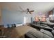 Spacious living room featuring a comfortable gray sectional sofa and tile flooring at 23104 W Kimberly Dr, Buckeye, AZ 85326