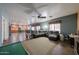 Spacious living room featuring tile floors, an open layout, and seamless access to the kitchen and dining area at 23104 W Kimberly Dr, Buckeye, AZ 85326