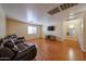 Living area with wood floors, a large TV, and plenty of space at 23104 W Kimberly Dr, Buckeye, AZ 85326