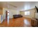 A large space with light walls and flooring, a cozy couch and a TV with entertainment center at 23104 W Kimberly Dr, Buckeye, AZ 85326