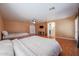 Spacious main bedroom features a ceiling fan, two beds, and an adjacent doorway to the main bathroom at 23104 W Kimberly Dr, Buckeye, AZ 85326