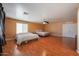Bright main bedroom features a ceiling fan, two beds, and wood-look flooring at 23104 W Kimberly Dr, Buckeye, AZ 85326