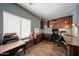 Office space with a built-in desk, drawers, shelves, and a large window at 23104 W Kimberly Dr, Buckeye, AZ 85326