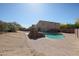 Large backyard pool with brickwork, desert landscaping, and views of the two-story house at 23104 W Kimberly Dr, Buckeye, AZ 85326
