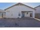 Exterior of the home showing the back patio with ceiling fan and a block wall surrounding the backyard at 2667 S 156Th Ave, Goodyear, AZ 85338