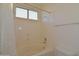 Bright bathroom offers a shower and tub combination with a window to allow natural light to enter at 2667 S 156Th Ave, Goodyear, AZ 85338