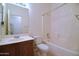 Clean bathroom featuring a shower-tub combination, toilet, and vanity with wooden cabinets at 2667 S 156Th Ave, Goodyear, AZ 85338