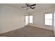 Spacious bedroom features neutral carpet, a ceiling fan, and direct access to the backyard through a glass door at 2667 S 156Th Ave, Goodyear, AZ 85338