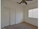 Bedroom featuring beige carpet, a closet with sliding doors, and a window with blinds at 2667 S 156Th Ave, Goodyear, AZ 85338