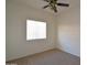 Bedroom featuring beige carpet, a ceiling fan, and a window with blinds at 2667 S 156Th Ave, Goodyear, AZ 85338