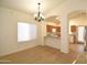 Cozy dining area with new laminate flooring, modern chandelier, and convenient access to the kitchen at 2667 S 156Th Ave, Goodyear, AZ 85338