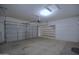 The garage features a garage door, built-in shelves, and ample space for parking and storage at 2667 S 156Th Ave, Goodyear, AZ 85338