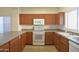 Functional kitchen with stainless steel appliances, wood cabinets, and plenty of room for cooking and storage at 2667 S 156Th Ave, Goodyear, AZ 85338