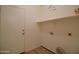 Laundry room featuring a door to the exterior, shelf, and washer/dryer hookups at 2667 S 156Th Ave, Goodyear, AZ 85338