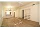 Open-concept living area with new laminate floors, custom built-ins, and arched doorways to the dining area at 2667 S 156Th Ave, Goodyear, AZ 85338