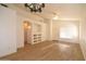 Bright and airy living room with new laminate floors, ceiling fan, and custom built-in shelving at 2667 S 156Th Ave, Goodyear, AZ 85338