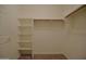 Walk-in closet featuring built-in shelving and hanging rods for optimal storage and organization at 2667 S 156Th Ave, Goodyear, AZ 85338
