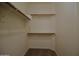 Spacious walk-in closet features shelving and clothes racks for a variety of storage options at 2667 S 156Th Ave, Goodyear, AZ 85338