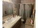 Functional bathroom with a single sink vanity, tiled countertop, and shower-tub combination at 277 W 16Th Ave, Apache Junction, AZ 85120