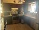 Traditional kitchen featuring dark wood cabinetry, stainless steel appliances, tile backsplash, and tile countertops at 277 W 16Th Ave, Apache Junction, AZ 85120