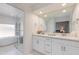 Bright bathroom boasts a double vanity, large mirror, and a glass-enclosed shower and tub at 3020 E Mission Ln, Phoenix, AZ 85028