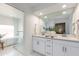 Bright bathroom features double sinks, quartz countertops and a glass enclosed shower at 3020 E Mission Ln, Phoenix, AZ 85028