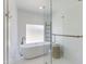 Modern bathroom features a freestanding tub behind a glass enclosure, with a tiled wall and decorative ladder at 3020 E Mission Ln, Phoenix, AZ 85028