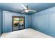 Stylish blue bedroom features a glass slider that opens to a backyard pool at 3020 E Mission Ln, Phoenix, AZ 85028